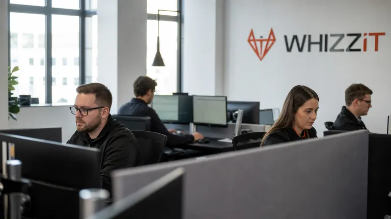 The open-plan WhizzIT office with staff working at dual-monitor desks
