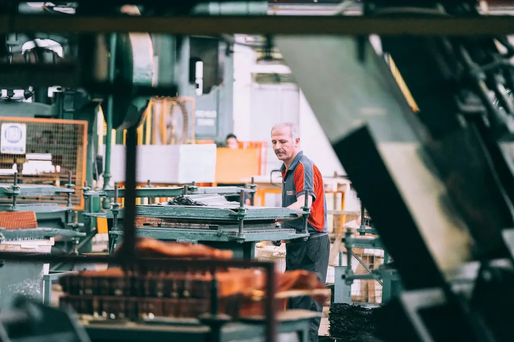 Operator working at machinery on a factory floor