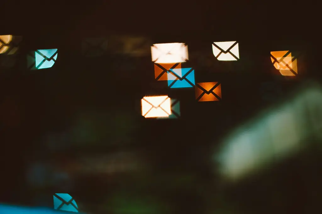 Glowing envelope-shaped lights against a dark background