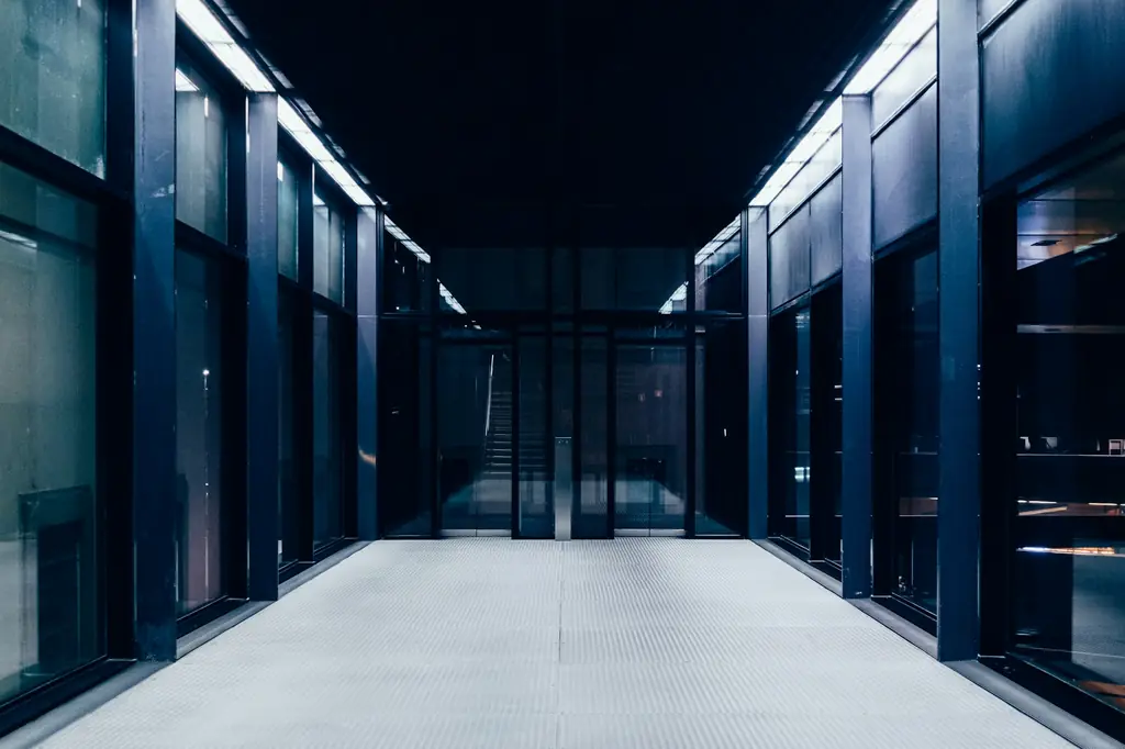 Long data centre corridor lined with glass-fronted server cabinets