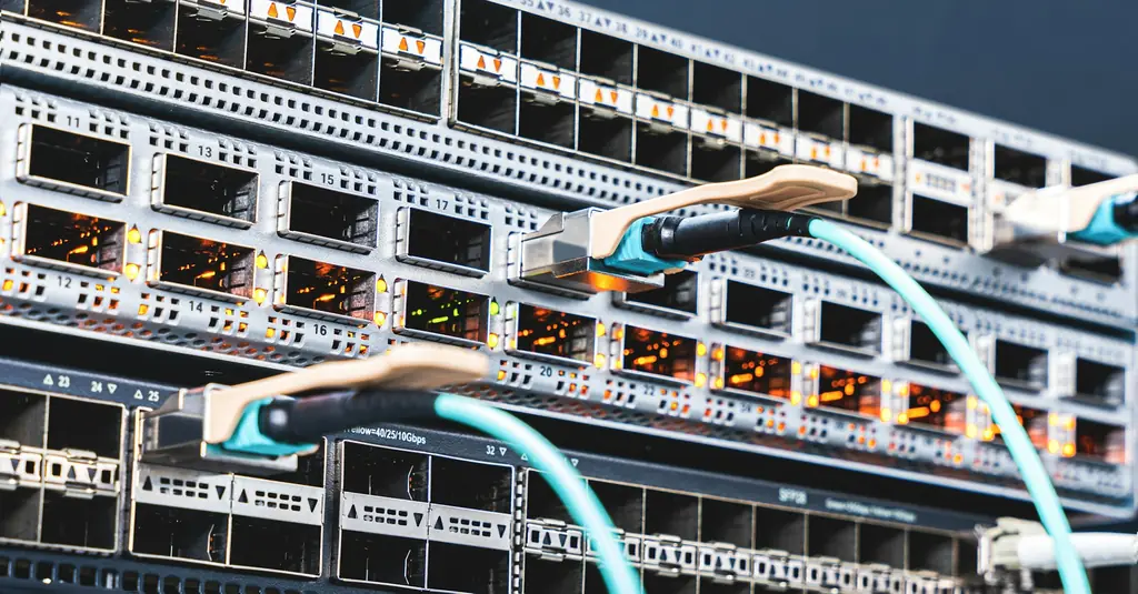 Data centre network switch with fibre connections plugged into its ports
