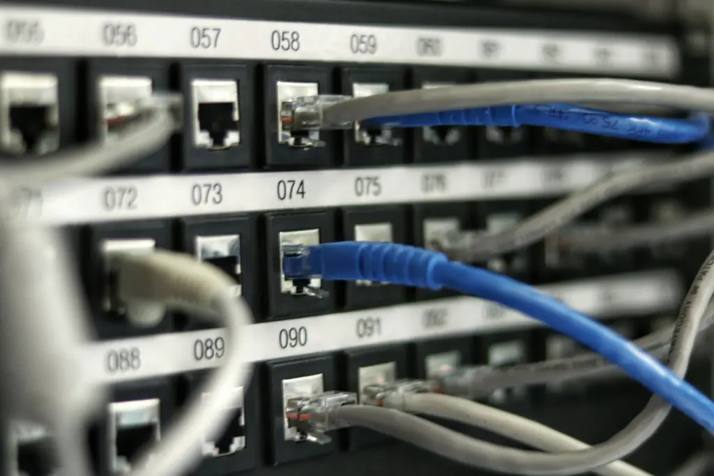 Numbered patch panel with blue and grey network cables connected