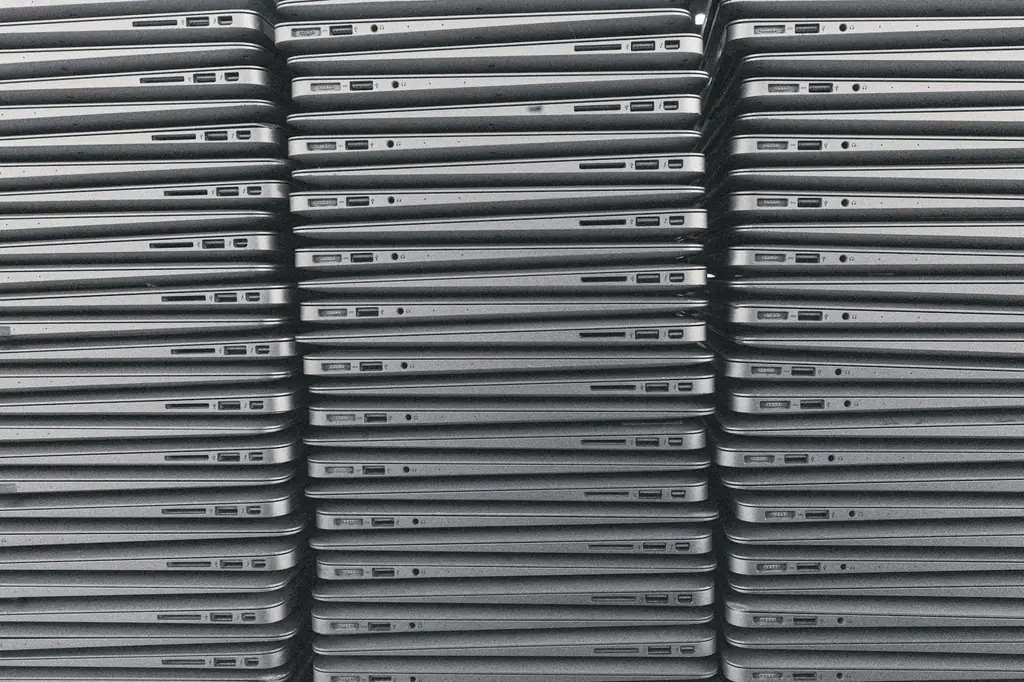Rows of stacked laptops ready for inventory